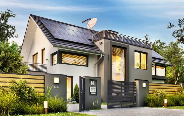 Beautiful modern house with garden and solar panels on the gable roof.