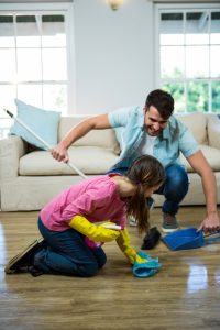 father cleaning house with her daughter