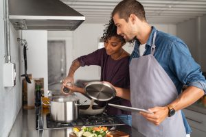 young couple in the kitchen cooking together