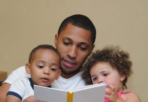A father reading to his kids