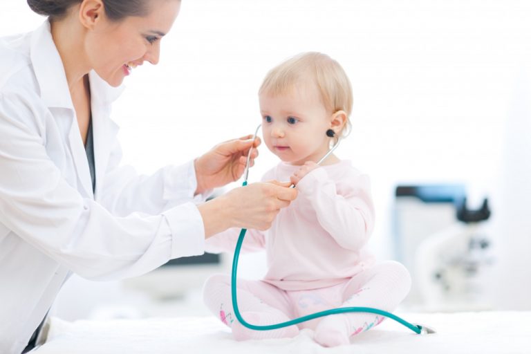 a baby with her doctor during checkup